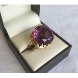An Egyptian 12k gold decorative dress ring set with a large purple stone possibly amethyst.