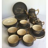 An oriental painted black ceramic teaset, hand painted in gold with Mount Fuji scene. Comprising;