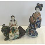 2 oriental figures of ladies in traditional dress, both a/f.