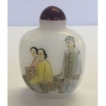 An opaque glass snuff bottle depicting oriental figures.