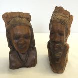 2 carved wooden African tribal heads, one signed, 21 & 23cm tall