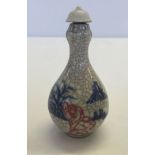 A crackle glaze snuff bottle with oriental decoration.