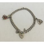 A hallmarked silver childs charm bracelet with 2 white metal charms. Total weight 10.4g.