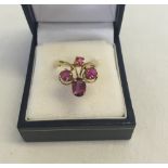 A 18ct gold ring set with 4 pink stones. Size L 1/2. Total weight approx 4.8g. Hallmark rubbed,