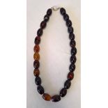 A necklace strung with highly polished oval agate beads. Clasp marked 925, length approx 17 inches.