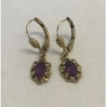 A pair of 14ct rolled gold earrings set with amethysts.