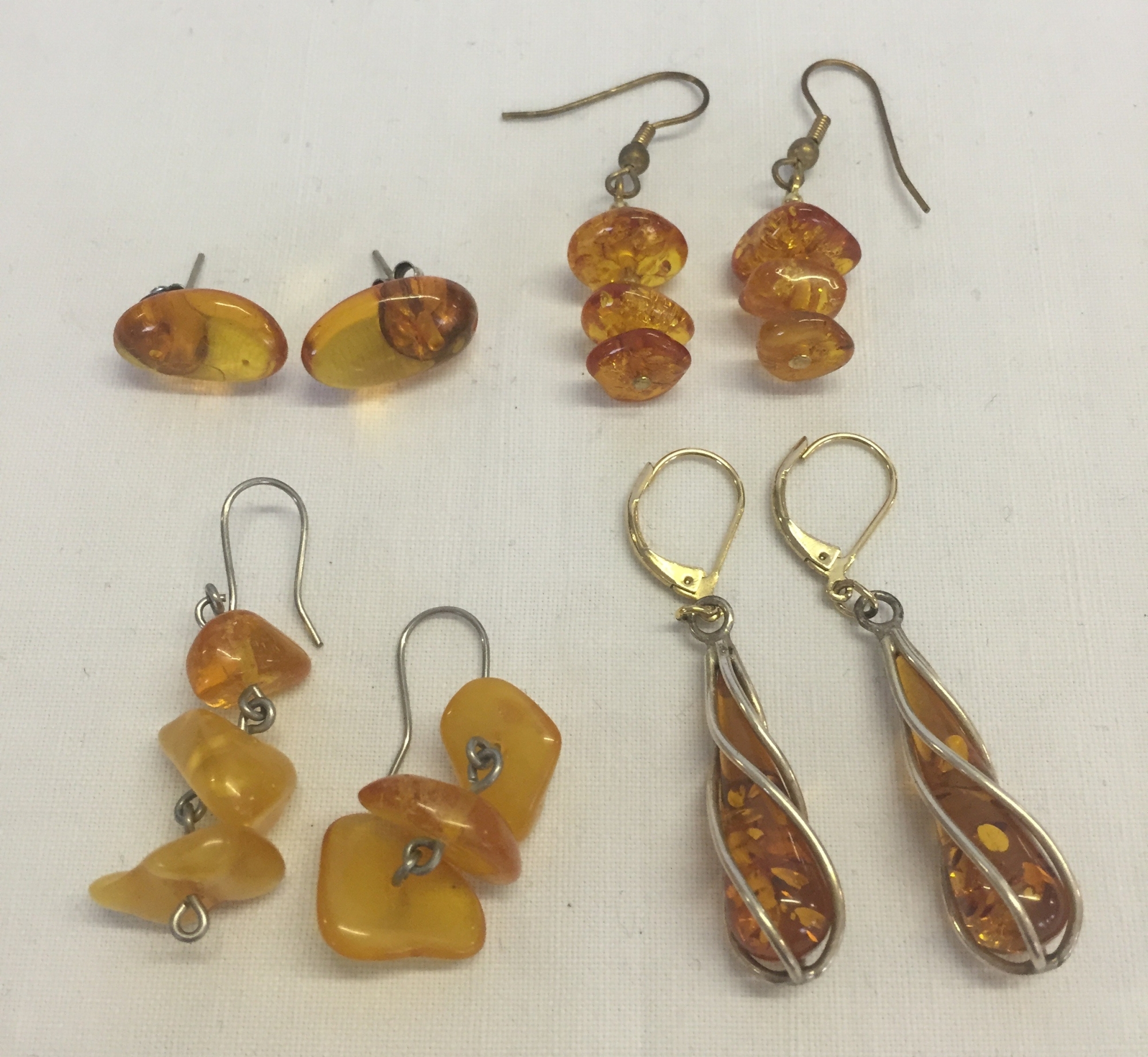 4 pairs of amber earrings (one pair with gold clasps.