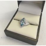 A 9ct white gold dress ring set with a marquise cut blue topaz. Decorative shoulders size N1/2