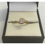 A 9ct gold diamond solitaire ring in twist design, Size P1/2, total weight 2g.