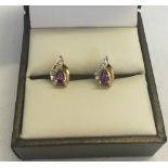 A pair of 9ct gold earrings set with teardrop amethysts and small diamonds.