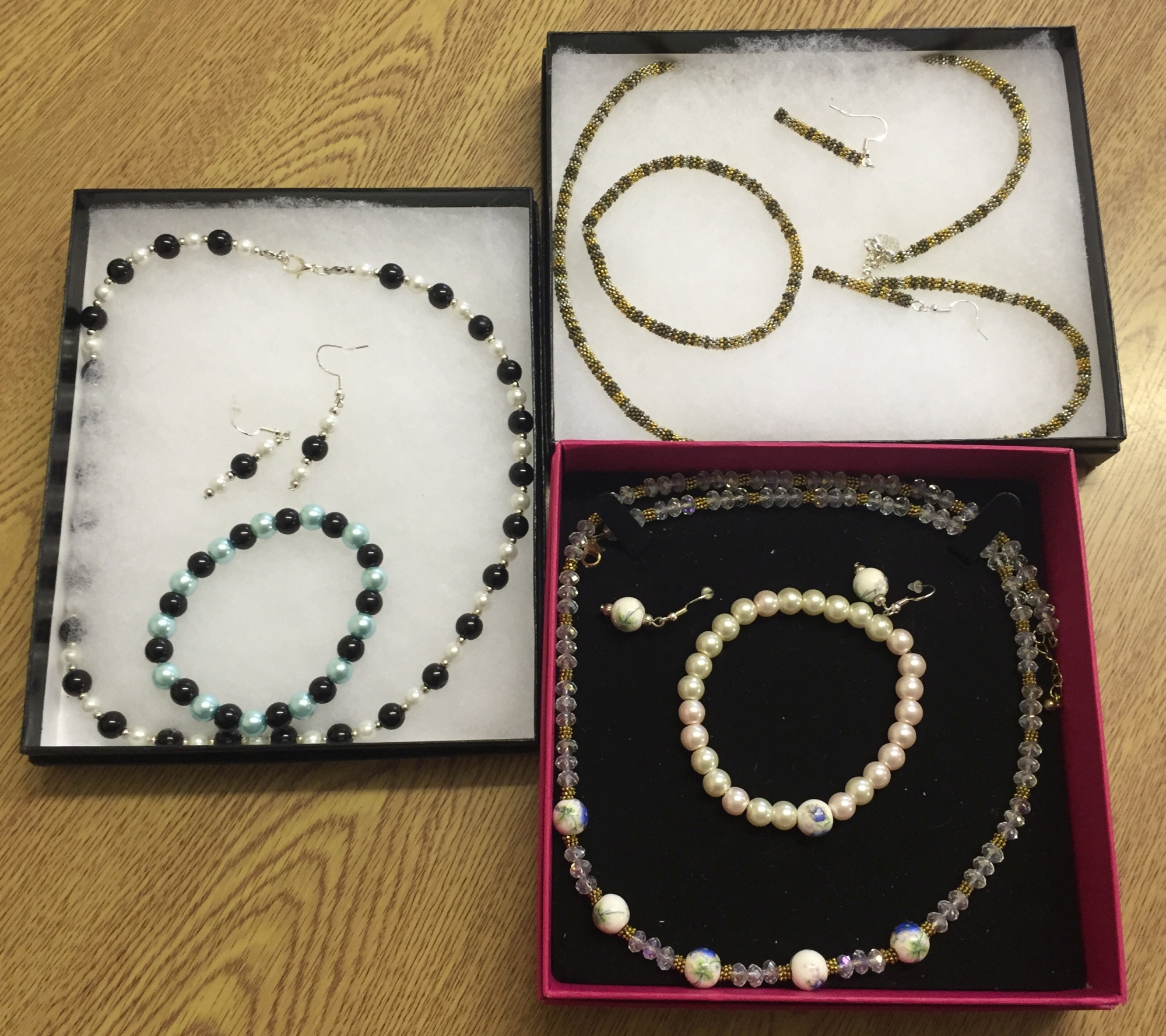 3 boxed costume jewellery sets comprising bracelet earrings and necklace.