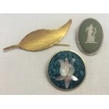 3 vintage brooches: 1) An oval Wedgwood green jasper ware brooch. 2) A rolled gold leaf design