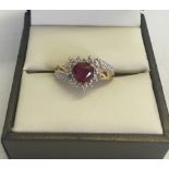 A 9ct gold created ruby and diamond dress ring in a heart shap. Size L total weight 2.1g.