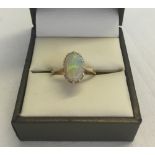 A 9ct gold & opal ring. Set with an oval opal. Size K. Total approx weight 2.3g.