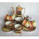 A Noritake coffee set with grazing sheep decoration, comprising; 6 coffee cups & saucers, cream jug,