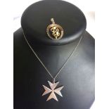 A Maltese silver pendant in the shape of a Maltese cross on a 925 silver chain. Together with a