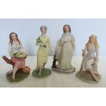 A set of 4 ceramic figures made by Franklin Mint depicting the four seasons