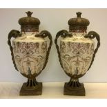 A Pair of large ceramic urns on brass pedestals with brass serpent handles.