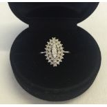 An 18ct white gold & diamond marquise shaped cluster ring. Size M 1/2. Approx weight 3.4g. Tests