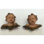 A pair of pottery wall hanging cherubs.