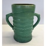 A large two handled green glaze vase stamped C.H. Brannam. Chips to rim of base.