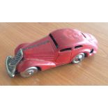 A Schuco c1930s red wind-up tin car - mechanism not working.