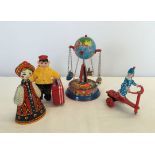 4 boxed tinplate toys to include Little Traveller and a wind up spinning carousel.