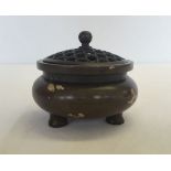 A small Chinese bronze charger with gold splash design and pierced lid. Approx 7x 8cm.