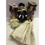 5 modern porcelain dolls, 3 on stands.