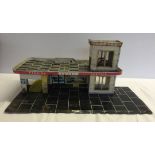 c1960s tin plate Shell garage with working car lift.