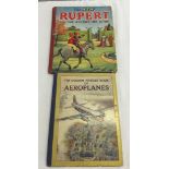 A Rupert annual together with an aeroplane picture book.