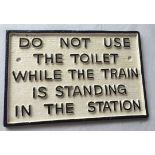 A cast iron painted railway toilet sign.