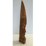 A tall carved wooden tribal head from Papua New Guinea with shell eyes, 57cm tall