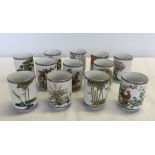A set of 12 Porcelain teacups with different designs made by Franklin Mint.