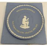 A boxed Wedgwood blue jasperware William Wilberforce slavery commemorative plate. 22cm diameter.