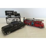 3 boxed tinplate vehicles. A minister Deluxe automatic car, a friction powered fire truck, and a