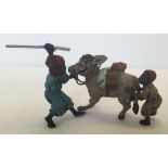 A small modern cold painted bronze figure of 2 boys and a donkey, approx 6cm high.