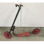 A vintage Raleigh metal and plastic childs scooter.