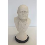 A white marble bust of Winston Churchill on a round base, approx 32cm high.