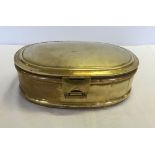 An oval shaped brass warming box.