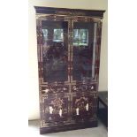 A Chinese red lacquer display cabinet with mother of pearl applied figures and gilt painted