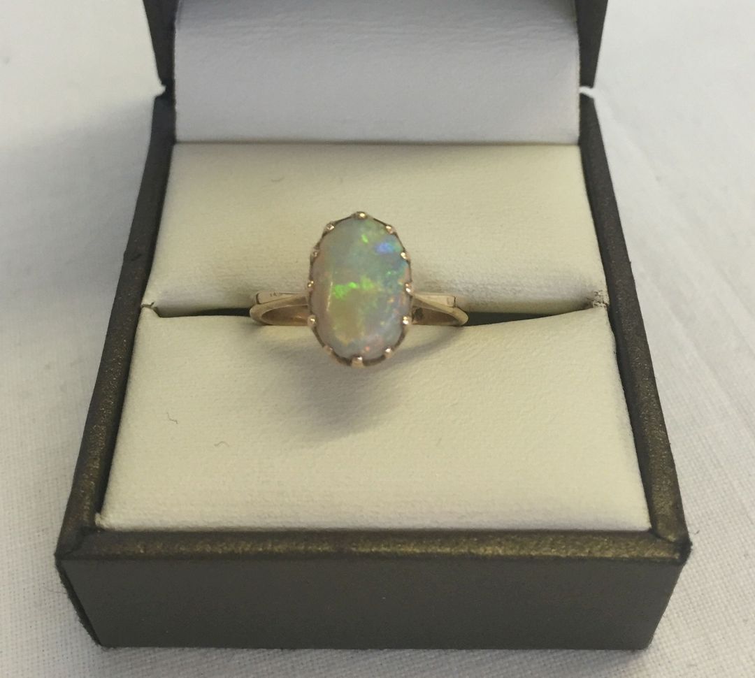 A 9ct gold & opal ring. Set with an oval opal. Size K. Total approx weight 2.3g.