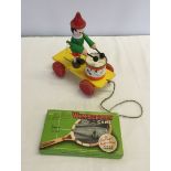 A boxed Wimbledon game together with a wooden pull-along drummer toy.