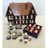 A small collection of ceramic thimbles together with a display stand.