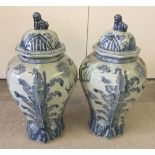 A large pair of blue and white urns with dragon decoration and Dogs of Fo on lids. Approx 58cm
