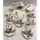 A Royal Windsor Rose pattern tea set comprising 12 side plates, a sandwich plate, 12 cups and