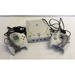 A Sega Dreamcast games console with leads and 2 controllers.