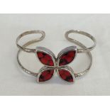 A Spanish 850 silver bangle set with red seeds.