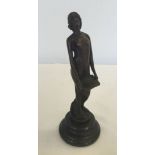 A small bronze figurine of an Art Nouveau style girl. Approx 19cm high on round marble base.