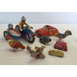 A collection of small tinplate toys to include vehicles and animals.